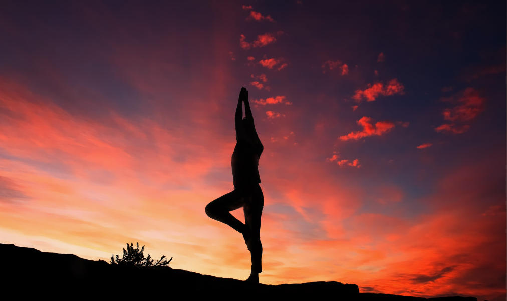 image of someone doing yoga at sunset