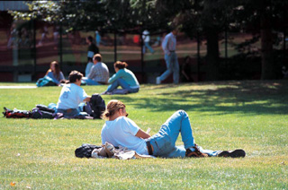 Students sitting and lying down on Johnston Green in the spring/summer